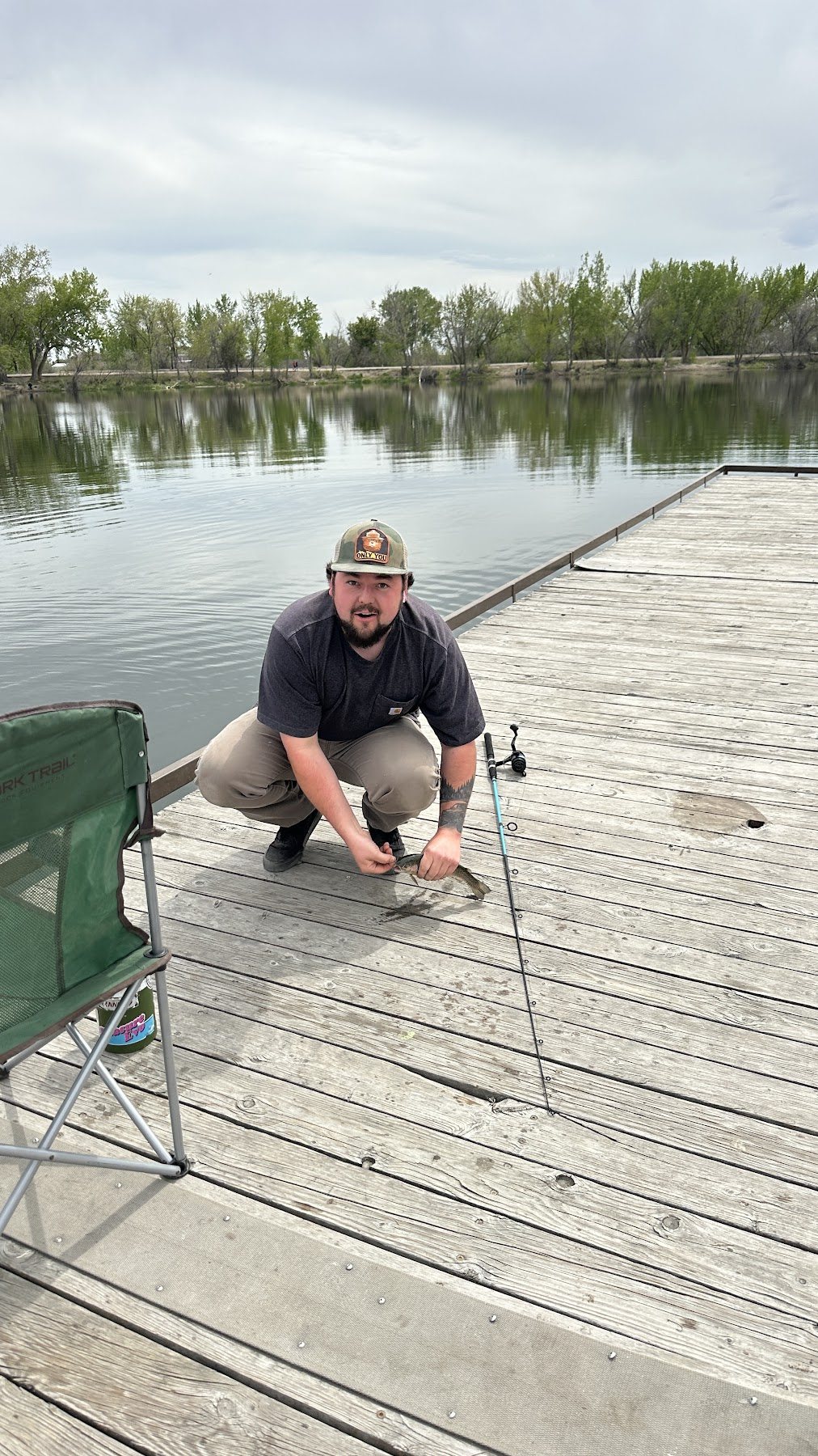 Family member crouching by the dock