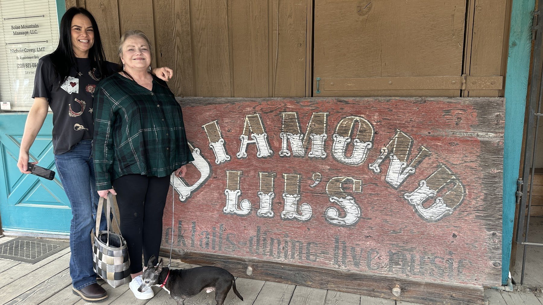 Two family members smiling outside Diamond Lil's